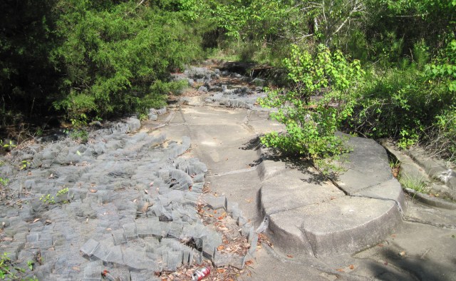 One can see the remains of a bend in the river molded into the concrete. The material on the left is the accordion-folded metal screening that was used to simulate woods and other vegetation along the waterway. (Photo by Ron Haines)